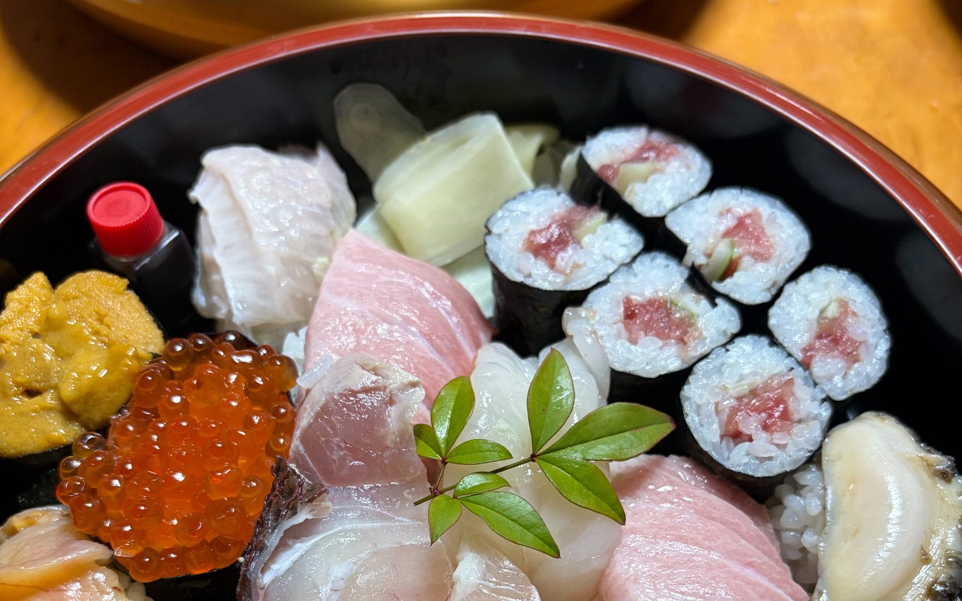 A sushi platter in a lacquer tub