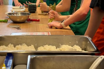 Exchange students folding gyoza