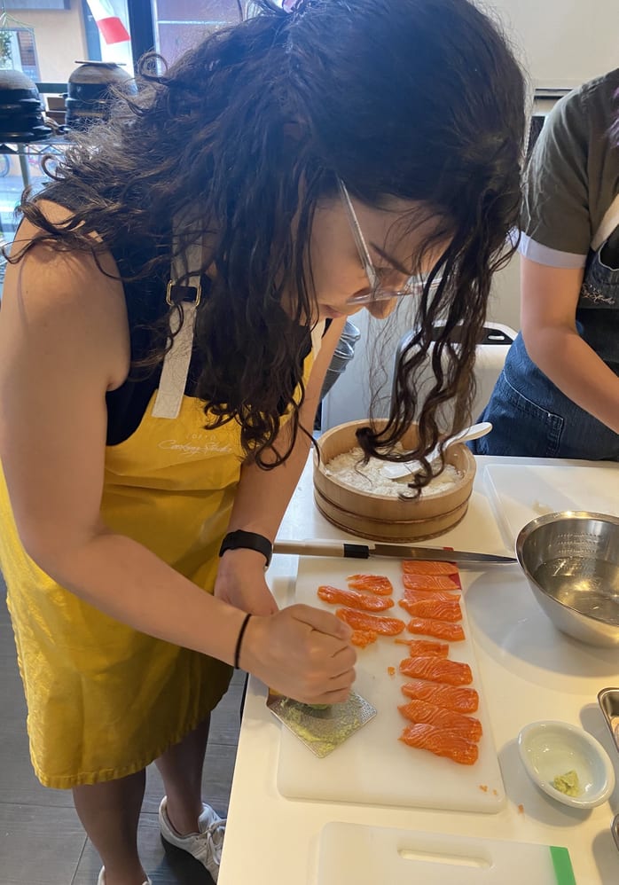 A guest slicing salmon