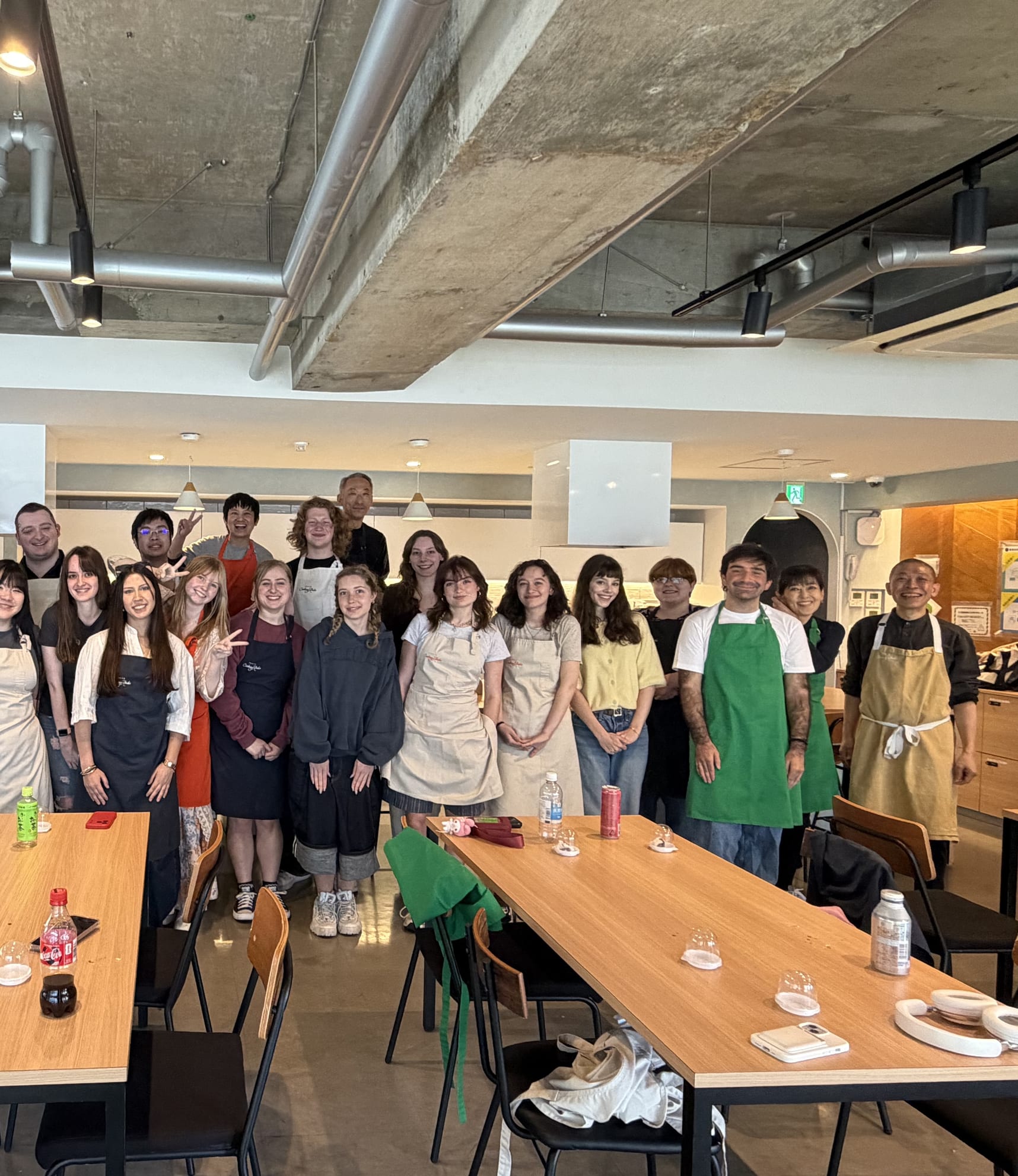 A large group class, everyone in aprons