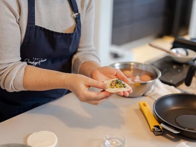 Hands folding gyoza