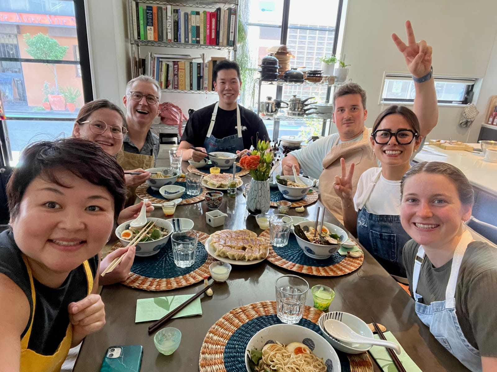 Guests sharing ramen and gyoza they made at the studio